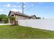 Side yard features a white vinyl fence, and a well-manicured lawn, adding to the property's curb appeal at 2972 Lake Saxon Dr, Land O Lakes, FL 34639