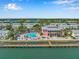 Aerial view of a waterfront property with a community pool, dock, and beautiful landscaping at 5215 Coquina Key Se Dr # A, St Petersburg, FL 33705