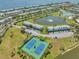 Beautiful community aerial featuring manicured landscaping, a serene lake, tennis courts, and well-maintained buildings at 5215 Coquina Key Se Dr # A, St Petersburg, FL 33705