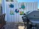 This picture displays an outdoor gas grill with decorative fish art on the fence at 5215 Coquina Key Se Dr # A, St Petersburg, FL 33705