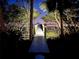 Scenic, private dock illuminated at night, with gate access and tranquil water views at 724 Bayshore Dr, Terra Ceia, FL 34250