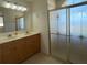 Bathroom featuring a double vanity, decorative shower, and tile floors, creating a functional and stylish space at 3447 Loveland Blvd, Port Charlotte, FL 33980