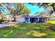 Charming single-story home featuring a well-maintained lawn, a screened porch and an attached two-car garage at 3464 Sutherland Dr, Palm Harbor, FL 34684