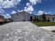 Charming single-story home with a two-car garage, stone accents, a well-manicured lawn, and a paver driveway at 4318 Pullet Ct, Lakewood Ranch, FL 34211