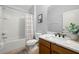 Bright bathroom featuring a shower-tub combo and marble countertop vanity at 7001 Interbay Blvd # 313, Tampa, FL 33616
