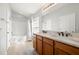 Bright bathroom featuring dual sinks, white countertops, and a combined tub and shower at 7001 Interbay Blvd # 313, Tampa, FL 33616