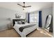 Cozy bedroom with a comfortable bed, blue curtains, neutral walls, and ceiling fan at 7001 Interbay Blvd # 313, Tampa, FL 33616