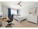 Bright bedroom featuring a desk, ceiling fan, a comfortable bed, and neutral decor at 7001 Interbay Blvd # 313, Tampa, FL 33616