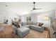 Bright living room with a large sectional sofa, ceiling fan, and hardwood flooring, with dining area views at 7001 Interbay Blvd # 313, Tampa, FL 33616