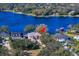 Aerial view of a luxury waterfront estate featuring a private dock and stunning lake views at 11710 N Armenia Ave, Tampa, FL 33612
