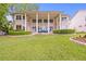 Backyard featuring a home with a covered patio overlooking a lush, manicured lawn at 11710 N Armenia Ave, Tampa, FL 33612