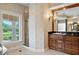 Well-appointed bathroom with beautiful wallpaper, a glass shower, and a single sink vanity at 11710 N Armenia Ave, Tampa, FL 33612