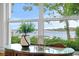 This bedroom features a table with a decorative plant and expansive water views at 11710 N Armenia Ave, Tampa, FL 33612