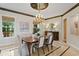 Formal dining room with a decorative chandelier, custom mouldings, and elegant furnishings for sophisticated entertaining at 11710 N Armenia Ave, Tampa, FL 33612