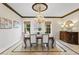 Formal dining room with a decorative chandelier, custom mouldings, and elegant furnishings for sophisticated entertaining at 11710 N Armenia Ave, Tampa, FL 33612