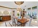 Formal dining room with a decorative chandelier, custom mouldings, and elegant furnishings for sophisticated entertaining at 11710 N Armenia Ave, Tampa, FL 33612