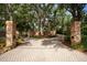 Paver driveway leading to a private estate with a gated entrance and lush landscaping for added curb appeal at 11710 N Armenia Ave, Tampa, FL 33612