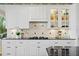 Modern kitchen featuring custom cabinetry, black granite countertops, and designer accents at 11710 N Armenia Ave, Tampa, FL 33612