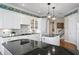 Stylish kitchen features black countertops, custom cabinets, and upscale appliances at 11710 N Armenia Ave, Tampa, FL 33612