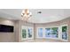 Bright living room featuring large windows with water views and an ornate chandelier at 11710 N Armenia Ave, Tampa, FL 33612