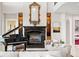 Living room featuring a fireplace, piano, and elegant finishes at 11710 N Armenia Ave, Tampa, FL 33612