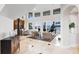 Bright living room featuring a piano, waterfront views, and comfortable seating arrangements at 11710 N Armenia Ave, Tampa, FL 33612