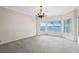 Bright living room with bay windows offering expansive water views and chandelier at 11710 N Armenia Ave, Tampa, FL 33612