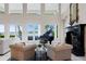 Bright living room with a fireplace, two stories worth of windows, and lake views for indoor-outdoor living at 11710 N Armenia Ave, Tampa, FL 33612
