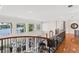 A second story loft features wrought iron railings, hardwood floors, and fantastic lake views at 11710 N Armenia Ave, Tampa, FL 33612