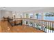 A stunning second story loft features an ornate iron railing and views of the nearby lake at 11710 N Armenia Ave, Tampa, FL 33612