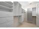 This walk-in closet offers ample storage with built-in shelves and drawers at 11710 N Armenia Ave, Tampa, FL 33612