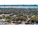 Stunning aerial view of a lush, green community with a home in the foreground and ocean in the distance at 5719 23Rd S Ave, Gulfport, FL 33707