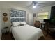 Cozy bedroom featuring a Murphy bed, ceiling fan, closet and desk space for comfortable living at 5719 23Rd S Ave, Gulfport, FL 33707