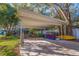 Open carport with storage and room for recreation equipment in the driveway of a charming home at 5719 23Rd S Ave, Gulfport, FL 33707