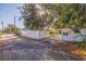Long driveway leading to a property with ample parking space and secure gated access at 5719 23Rd S Ave, Gulfport, FL 33707