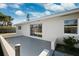 Backyard patio with sliding doors, and mature plantings offering privacy at 6666 Pinellas Point S Dr, St Petersburg, FL 33712