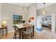 Charming dining area with modern lighting, wood floors, and a view into the kitchen at 22 Penzance Ct, Safety Harbor, FL 34695