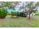 This home features a screened lanai and a large, well-maintained backyard with lush landscaping at 5004 Sandy Brook Cir, Wimauma, FL 33598