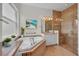 Beautiful bathroom features a large soaking tub and a glass enclosed shower with tile surround at 5004 Sandy Brook Cir, Wimauma, FL 33598
