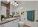 Clean, functional bathroom with large mirror, ample counter space, and tiled shower with glass door at 5004 Sandy Brook Cir, Wimauma, FL 33598