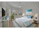 Bright bedroom featuring plantation shutters, light blue accents and a comfortable bed at 5004 Sandy Brook Cir, Wimauma, FL 33598