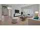 Bright living room featuring plantation shutters, neutral furnishings, and stylish decor at 5004 Sandy Brook Cir, Wimauma, FL 33598