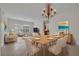Open-concept living and dining space features a modern chandelier, stylish decor, and natural light at 5004 Sandy Brook Cir, Wimauma, FL 33598