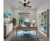 Well-lit office space with a ceiling fan, built-in shelving, and a large window for natural light at 5004 Sandy Brook Cir, Wimauma, FL 33598