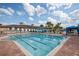 Stunning community pool with lounge chairs and blue and white awning under beautiful sunny skies at 5004 Sandy Brook Cir, Wimauma, FL 33598