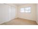 Bedroom featuring carpeting, closet, and a window at 51 Lexington Dr, Dunedin, FL 34698