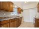 This kitchen features brown cabinets, stainless steel sinks, and tile backsplash at 51 Lexington Dr, Dunedin, FL 34698