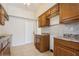 This kitchen features brown cabinets, tile countertops, and stainless steel double sinks at 51 Lexington Dr, Dunedin, FL 34698