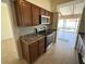 This kitchen features tile floors, brown cabinets, and stainless steel appliances at 51 Lexington Dr, Dunedin, FL 34698