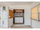 Functional laundry room with washer, dryer, and storage shelves at 51 Lexington Dr, Dunedin, FL 34698